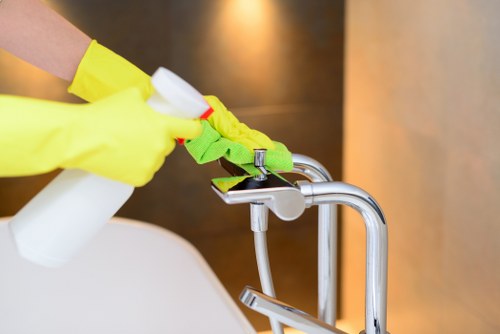 Cleaner carrying out safe cleaning with protective gear and hazard awareness