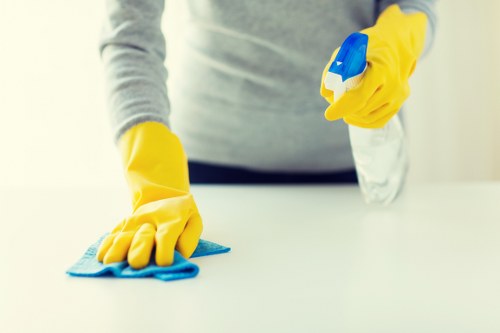 Emergency-ready cleaner near marked wet floor and safety signage